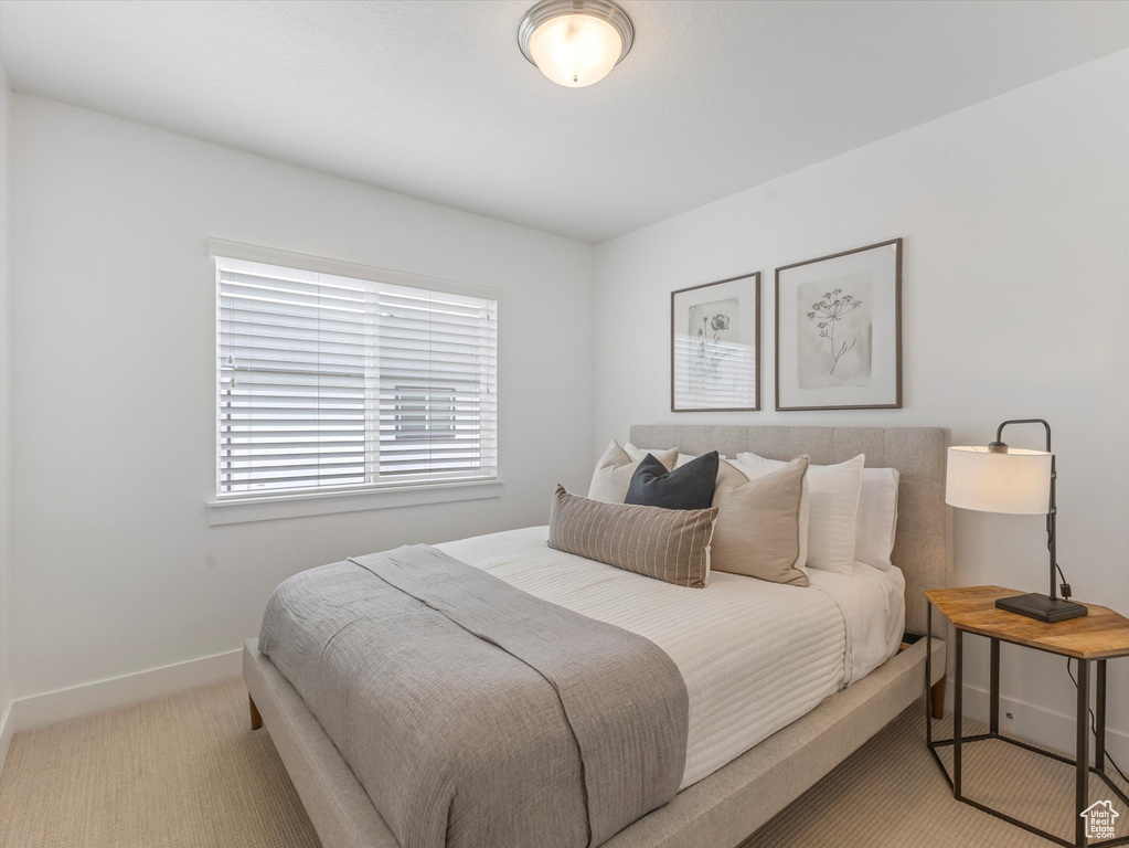 Bedroom featuring baseboards and carpet