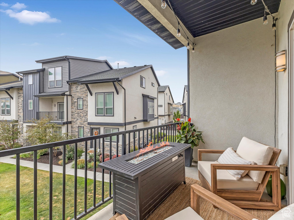 Balcony featuring a residential view and a fire pit