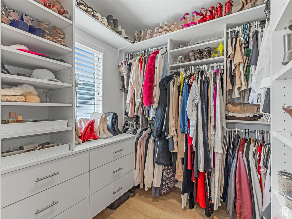 Walk in closet featuring light wood-style flooring