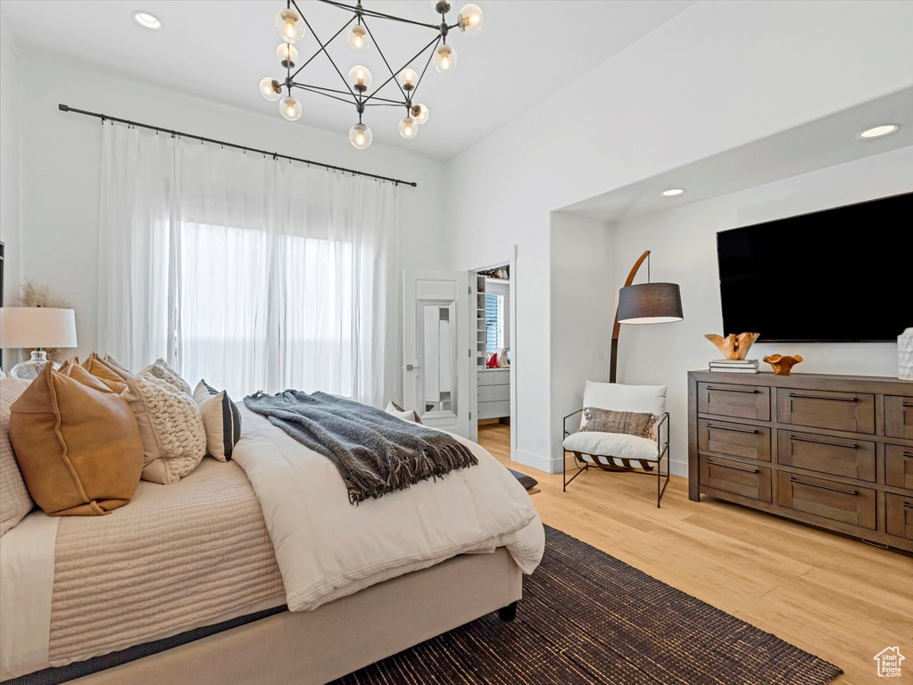 Bedroom with a chandelier, light wood-style flooring, and recessed lighting