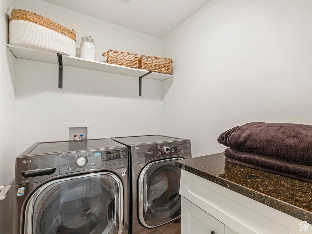 Washroom featuring washing machine and dryer
