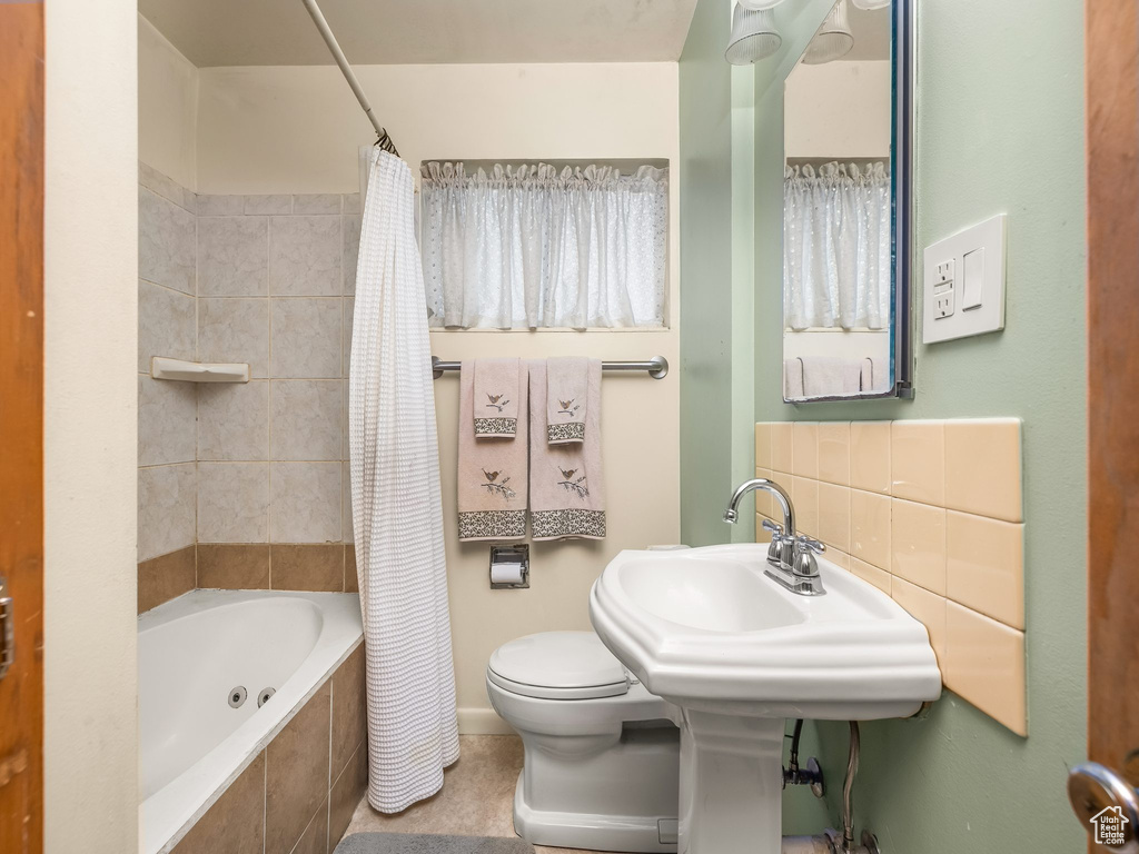 Full bathroom with tiled shower / bath and tile patterned floors