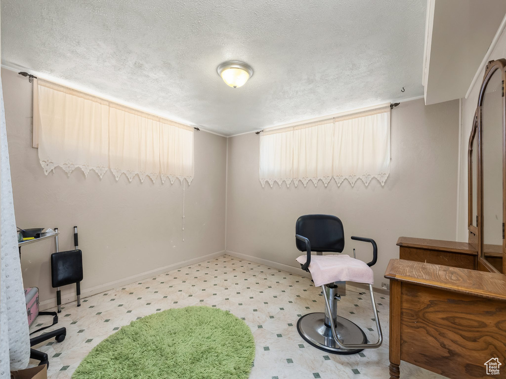 Office space featuring a textured ceiling and tile patterned floors