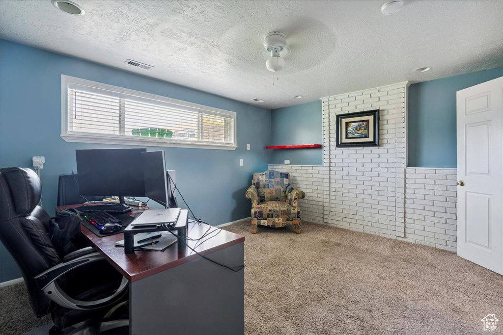 Office with carpet, a ceiling fan, and a textured ceiling