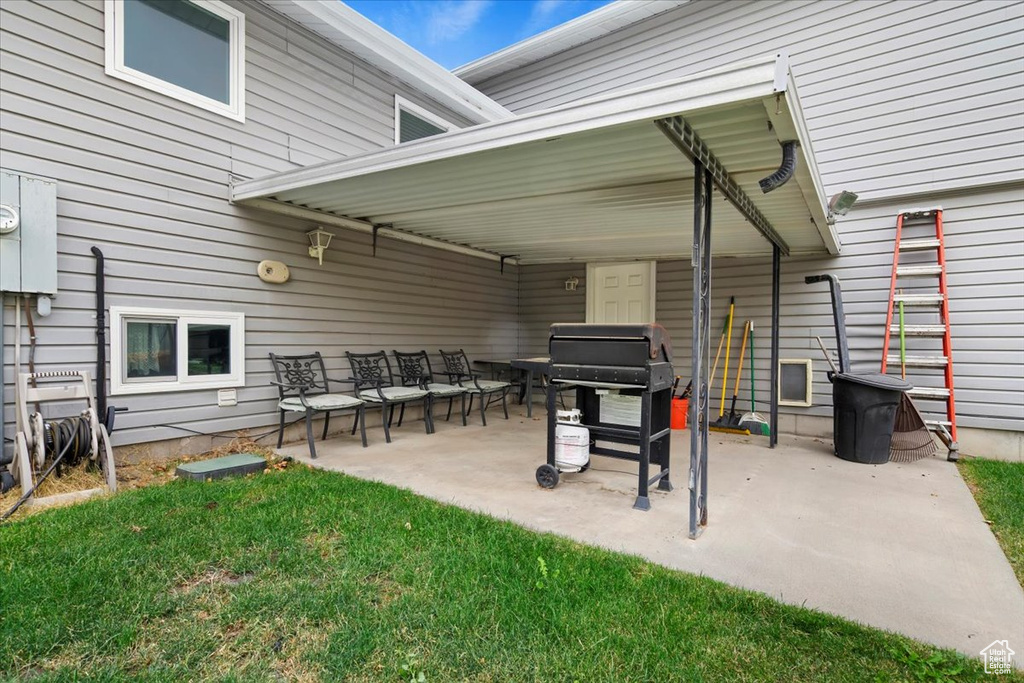 View of patio with area for grilling and an outdoor living space