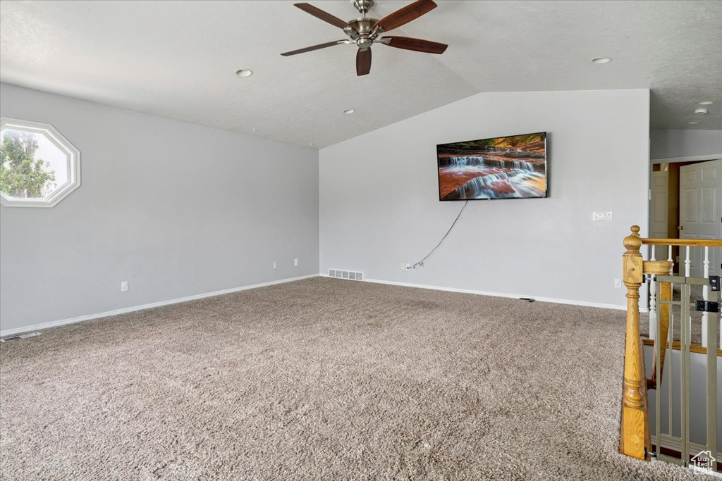 Carpeted spare room featuring ceiling fan, lofted ceiling, and recessed lighting