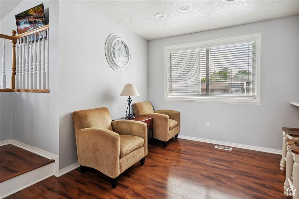 Sitting room featuring wood finished floors and a textured ceiling