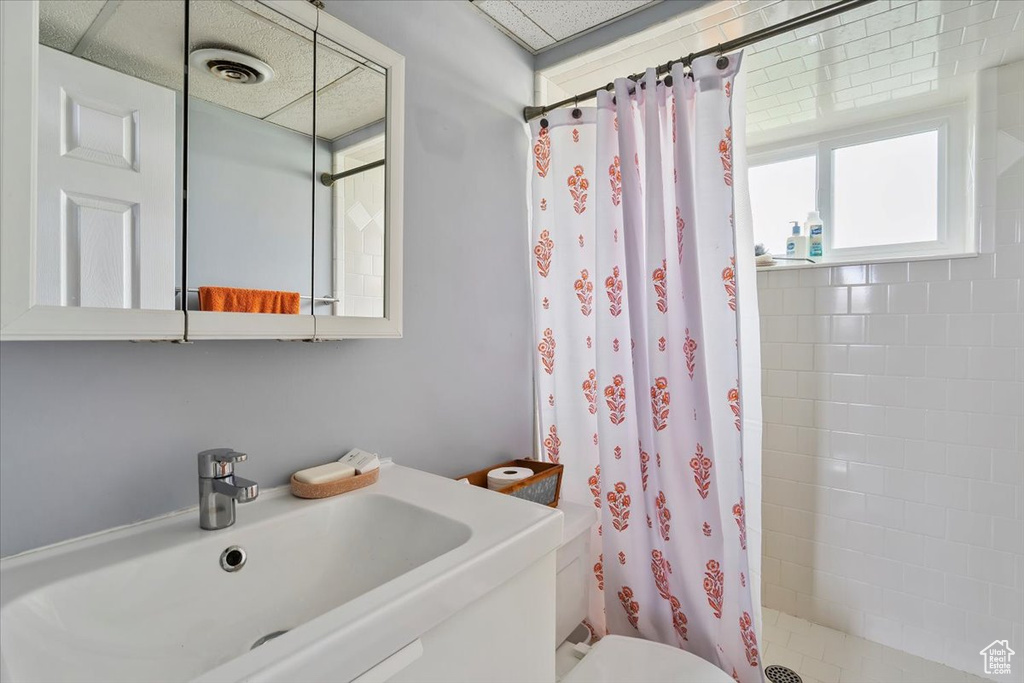 Bathroom featuring a stall shower and toilet