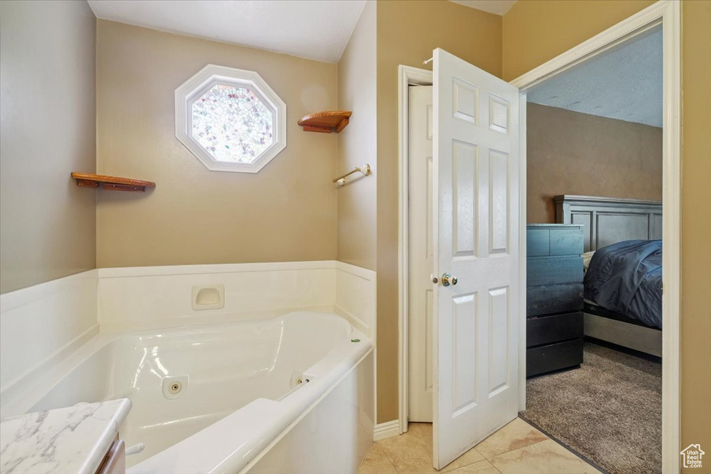 Full bathroom with a jetted tub and connected bathroom
