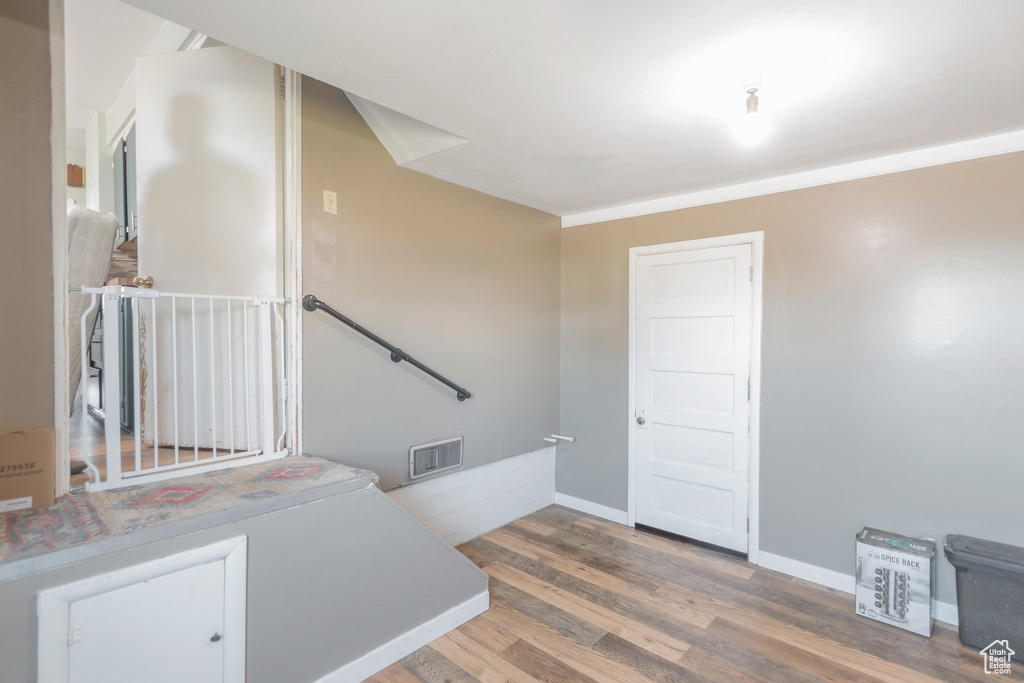 Stairway featuring wood finished floors and baseboards