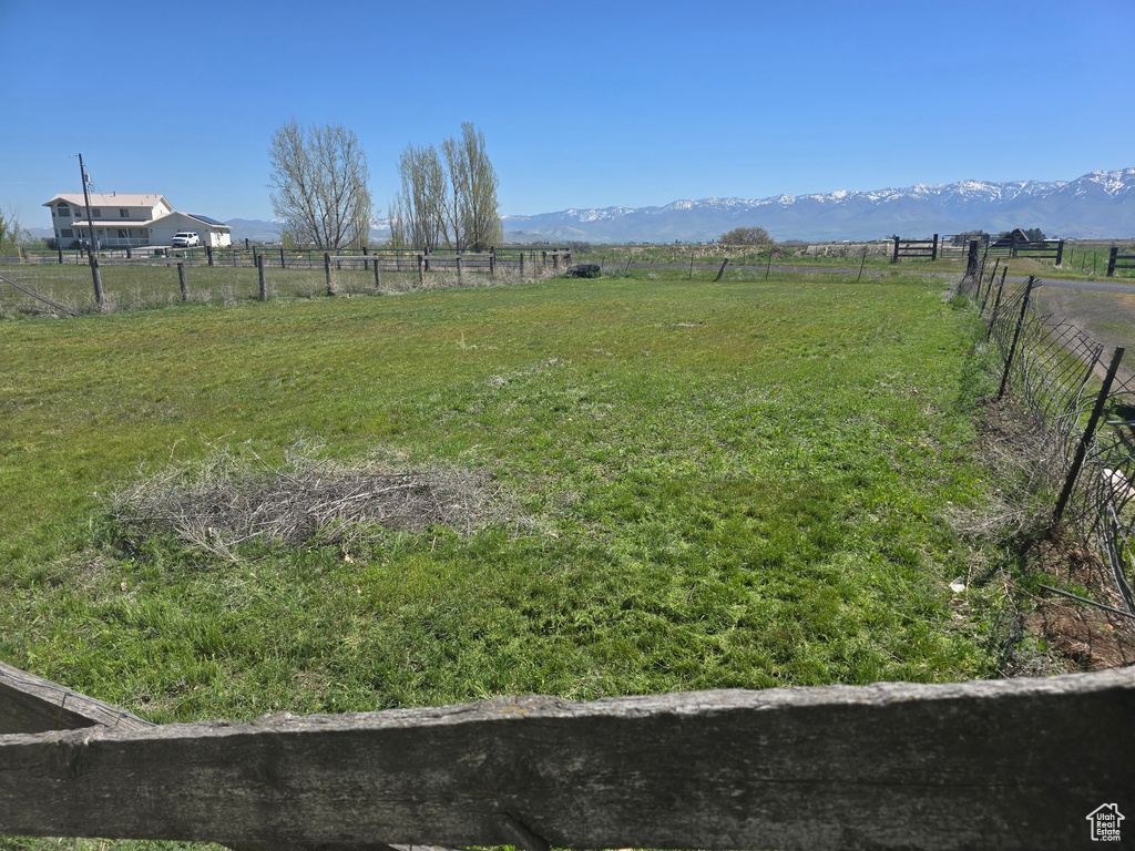 View of yard featuring a rural view and a mountain view