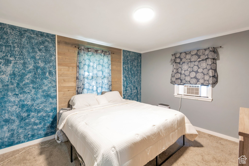 Carpeted bedroom with ornamental molding and cooling unit