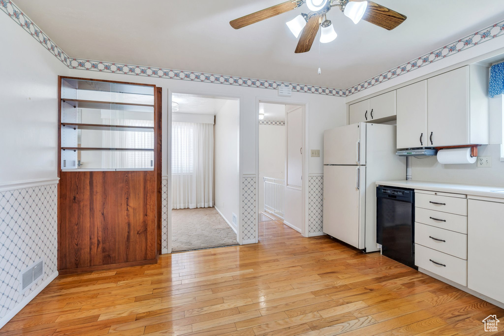Kitchen featuring dishwasher, freestanding refrigerator, light countertops, light wood-type flooring, and ceiling fan