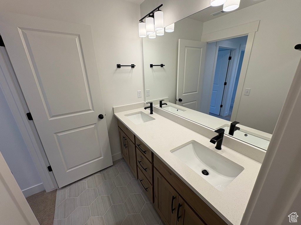 Bathroom with double vanity and tile patterned floors
