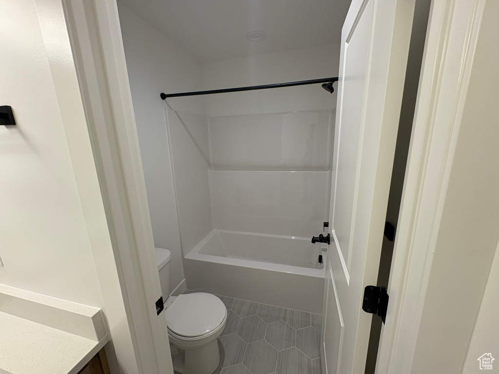 Bathroom with  shower combination, tile patterned floors, and vanity