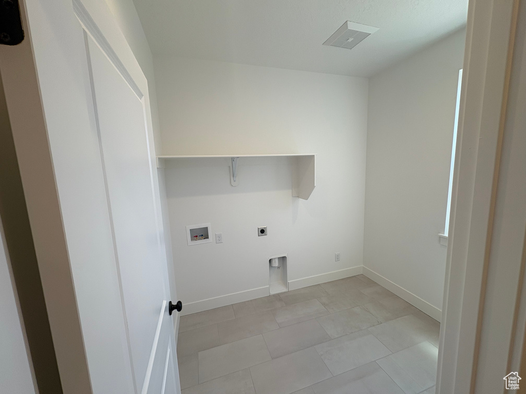 Laundry room featuring electric dryer hookup and washer hookup