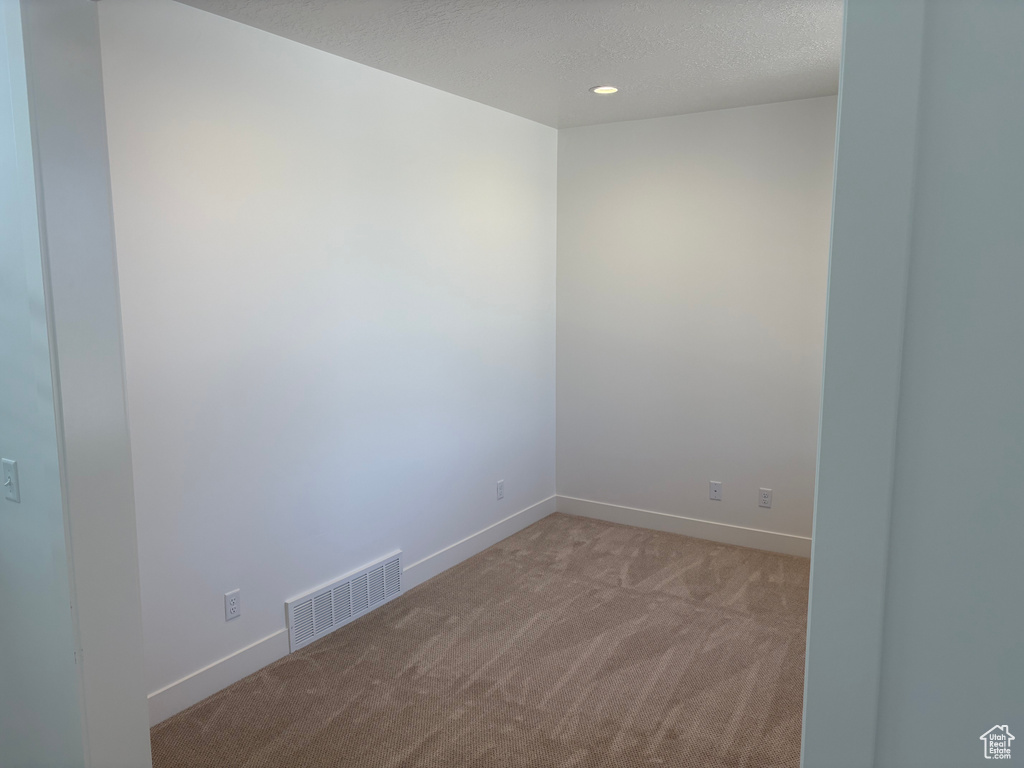 Carpeted empty room with baseboards and recessed lighting