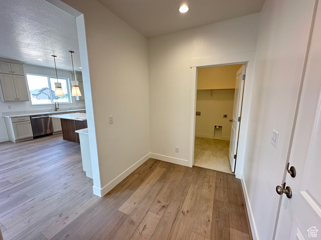 Corridor featuring light wood-style floors and recessed lighting