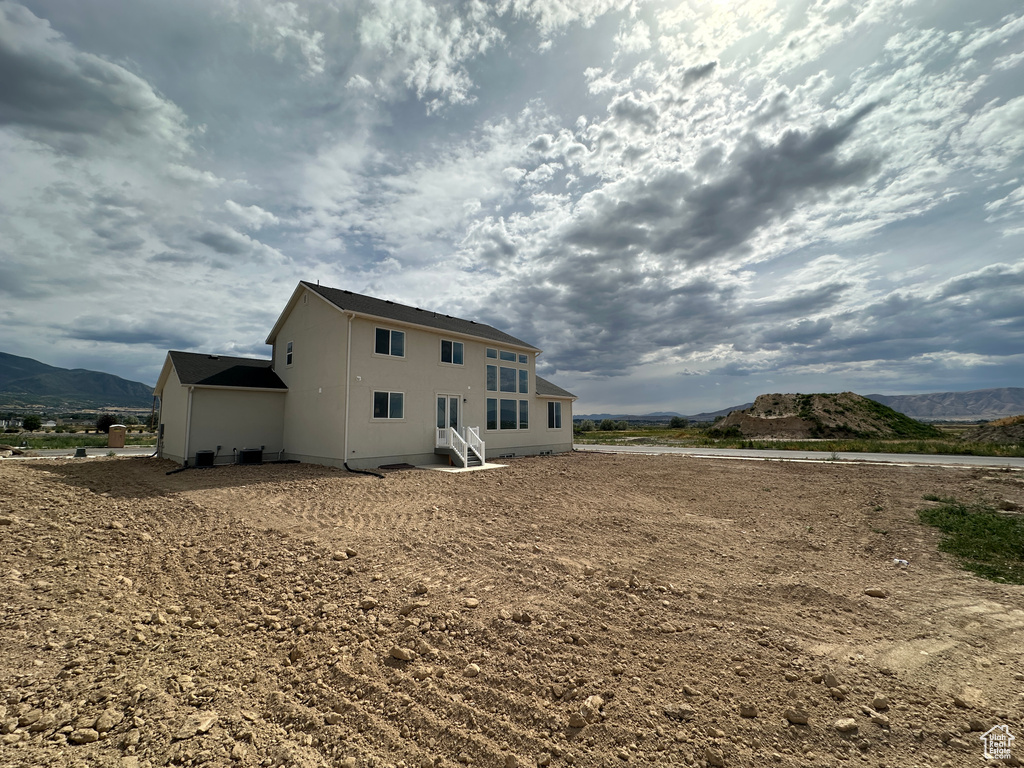 Back of property featuring a mountain view