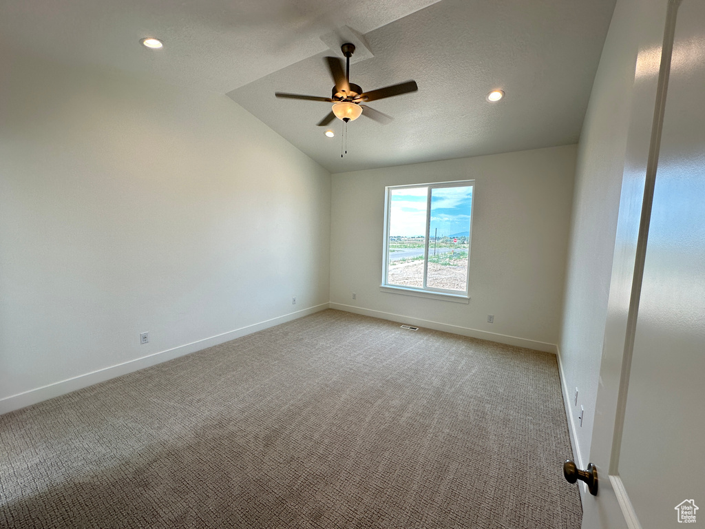 Spare room with light colored carpet, lofted ceiling, ceiling fan, and recessed lighting