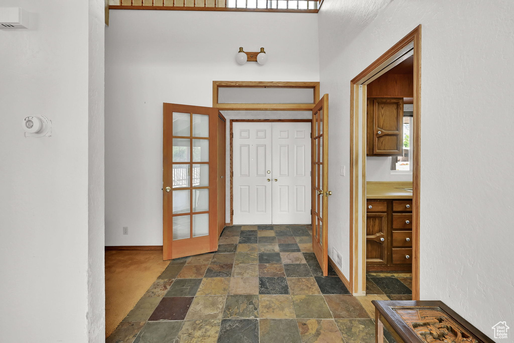 Entryway with stone tile flooring and french doors