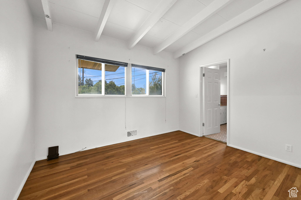 Unfurnished room featuring wood finished floors and baseboards