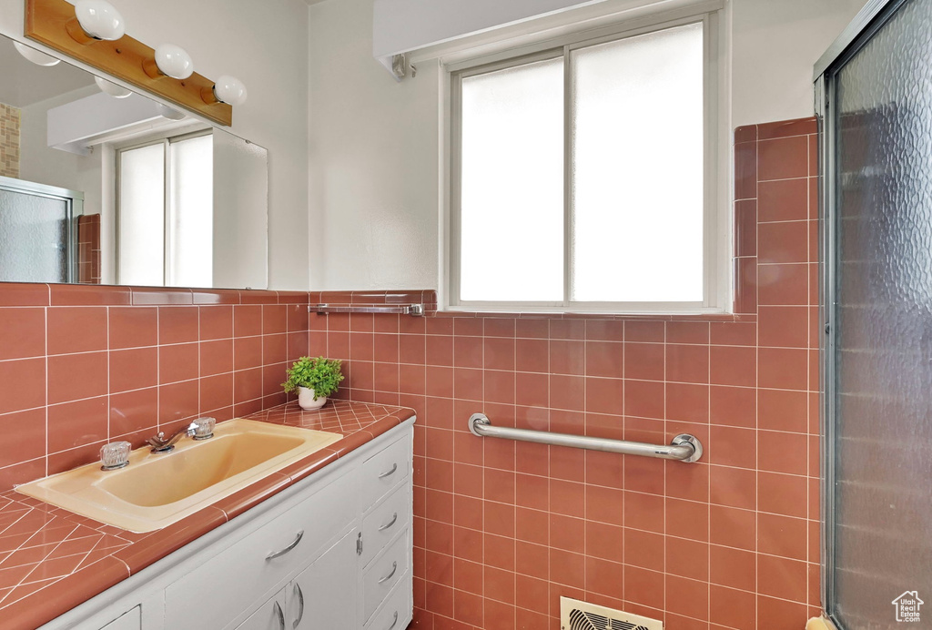 Bathroom with vanity and an enclosed shower