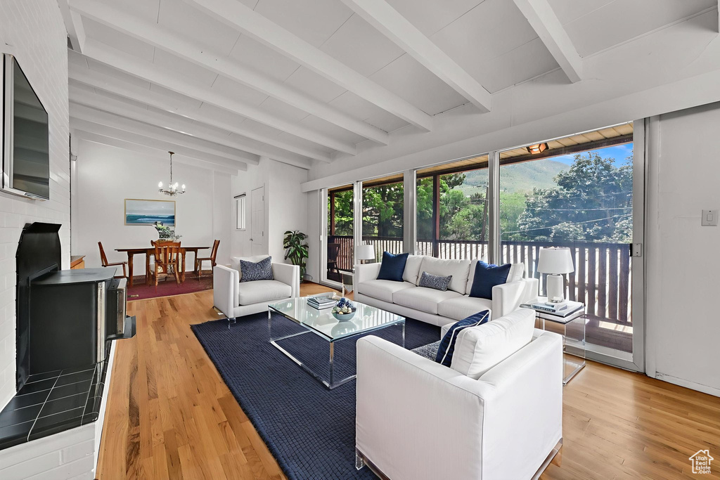 Living area with light wood-type flooring and a chandelier