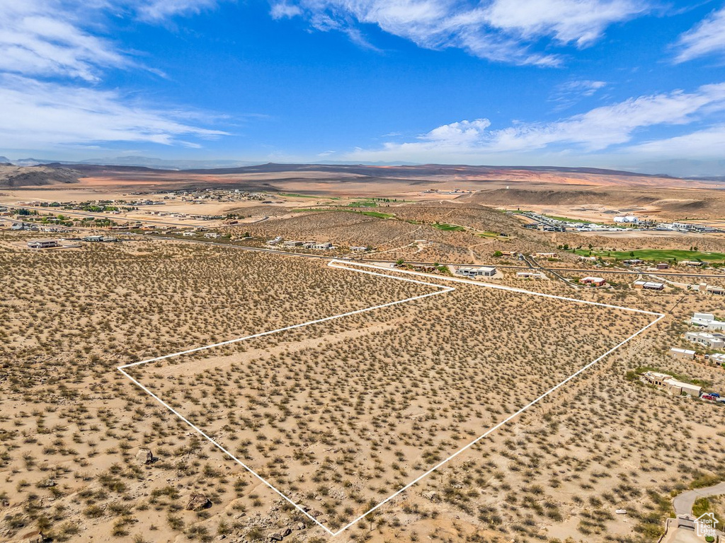 Aerial view of sparsely populated area with mountains and a desert landscape