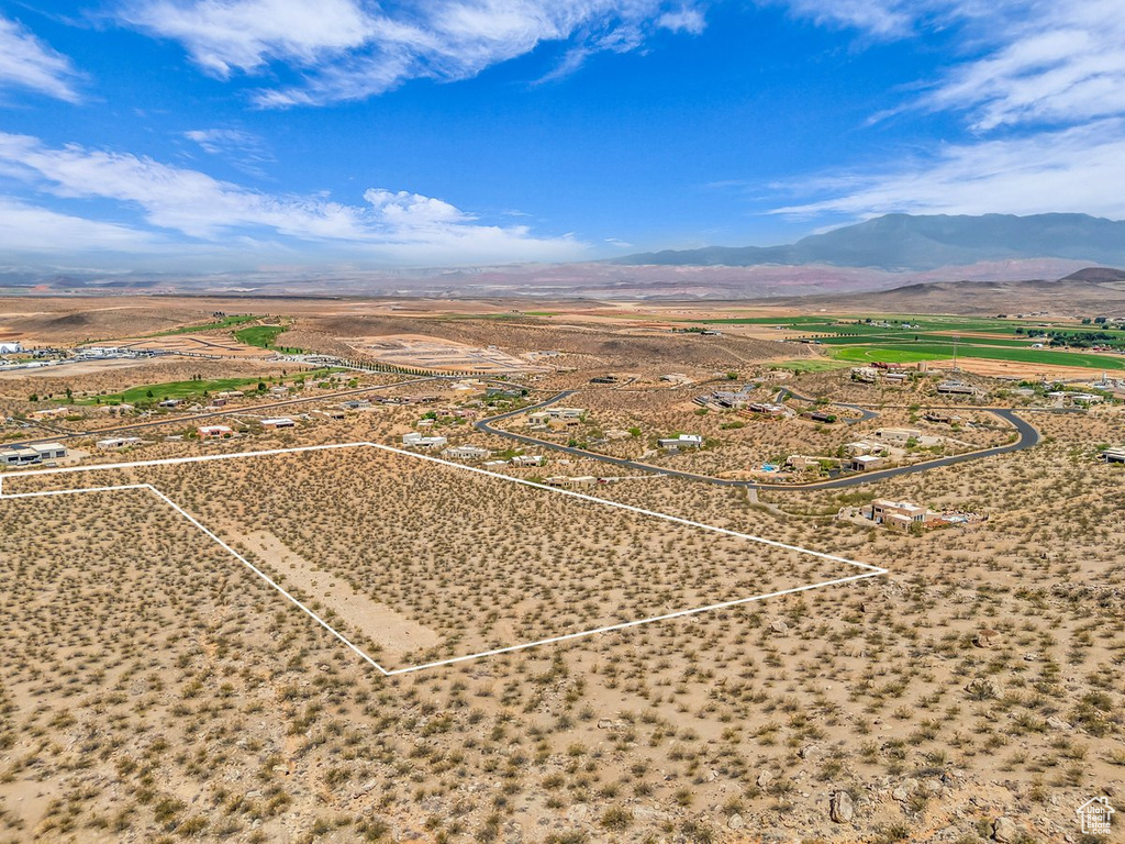 Overview of rural landscape featuring a mountainous background and property parcel outlined
