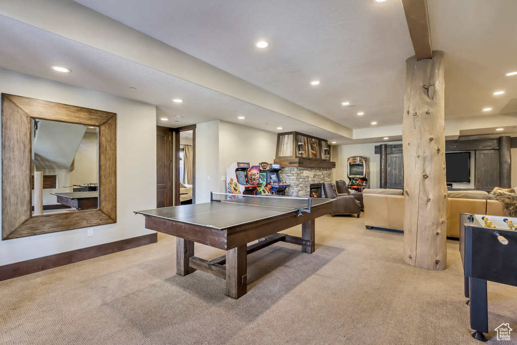 Rec room with light carpet, recessed lighting, and a stone fireplace