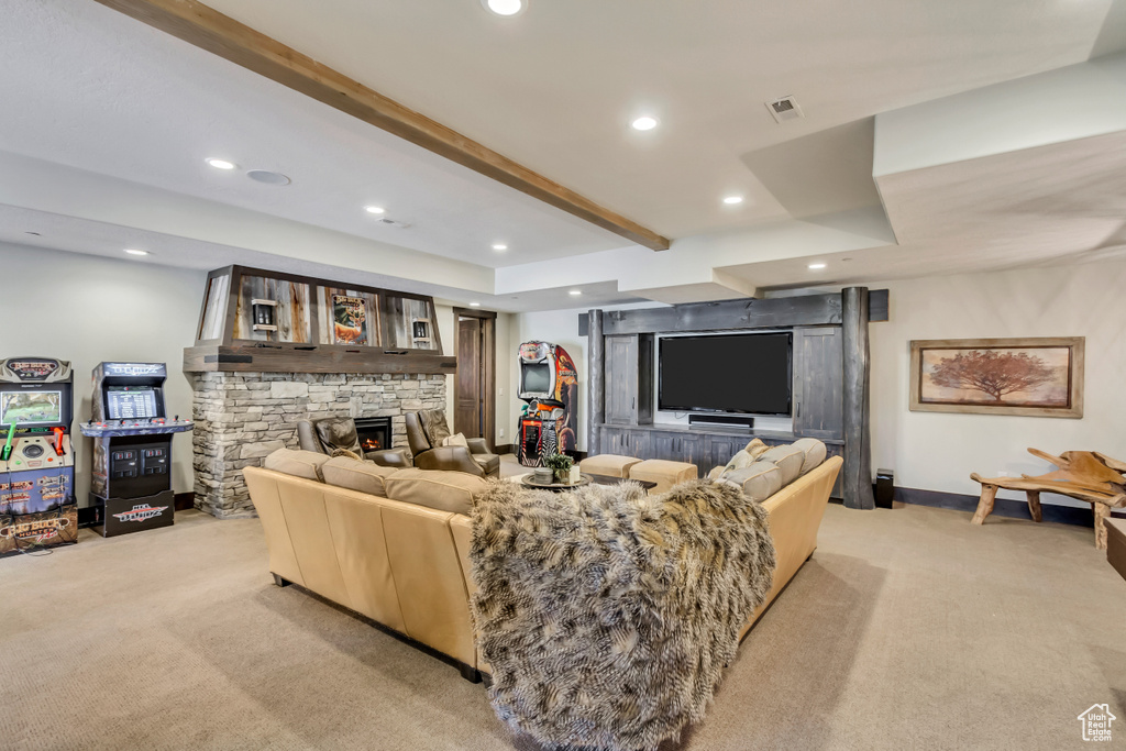 Living area featuring light colored carpet, a fireplace, recessed lighting, and beamed ceiling