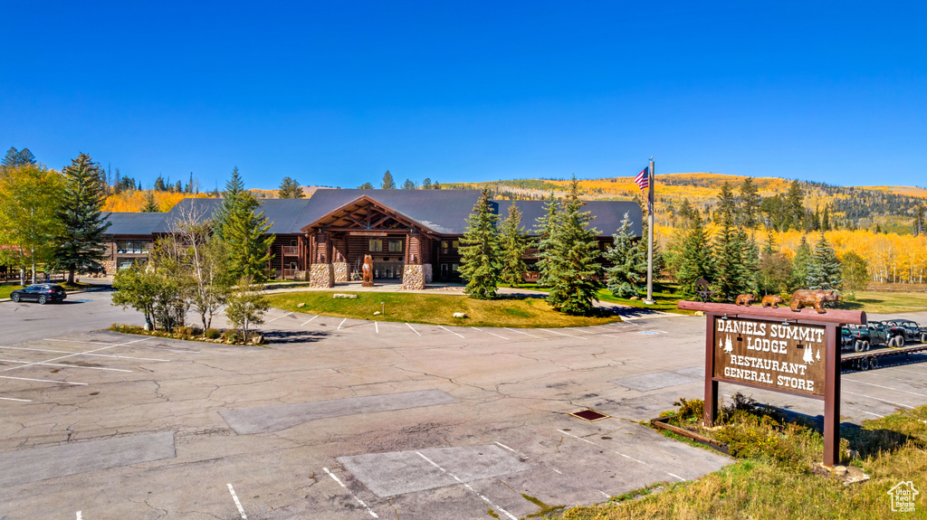 View of front of property featuring uncovered parking and stone siding