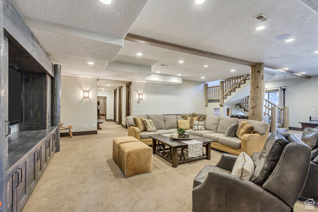 Living room featuring light colored carpet, stairway, and recessed lighting