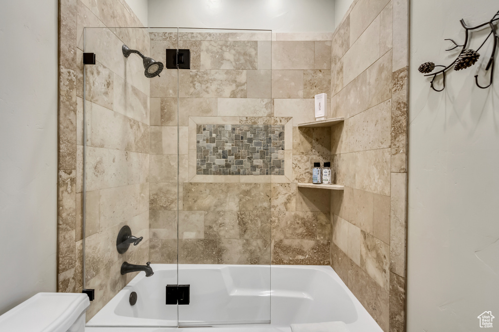Bathroom featuring bathing tub / shower combination and toilet