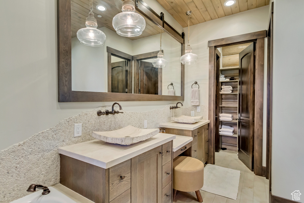Full bathroom with wood ceiling, recessed lighting, vanity, a tub to relax in, and tile patterned floors