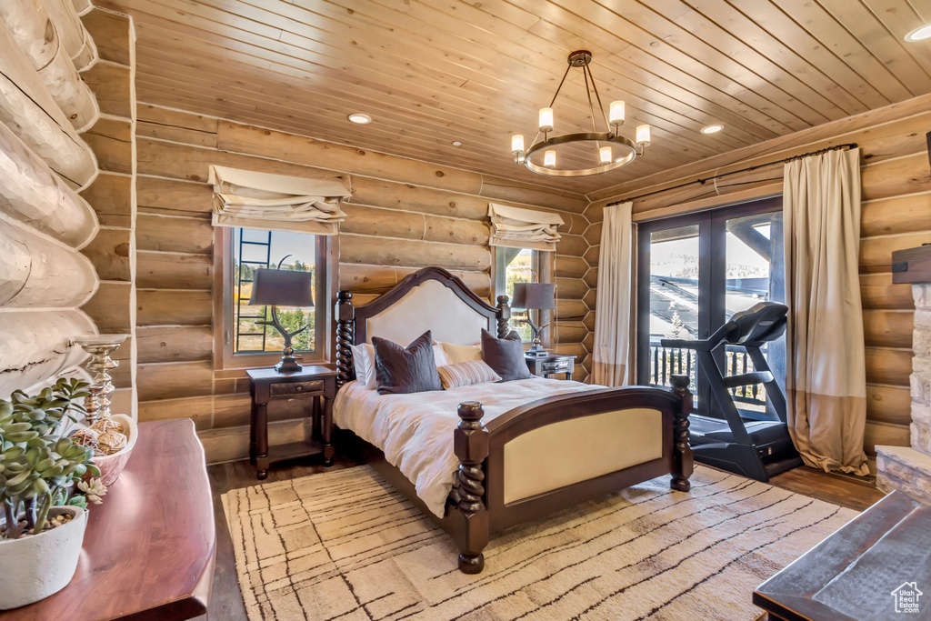 Bedroom featuring rustic walls, wood-type flooring, access to outside, wood ceiling, and a chandelier