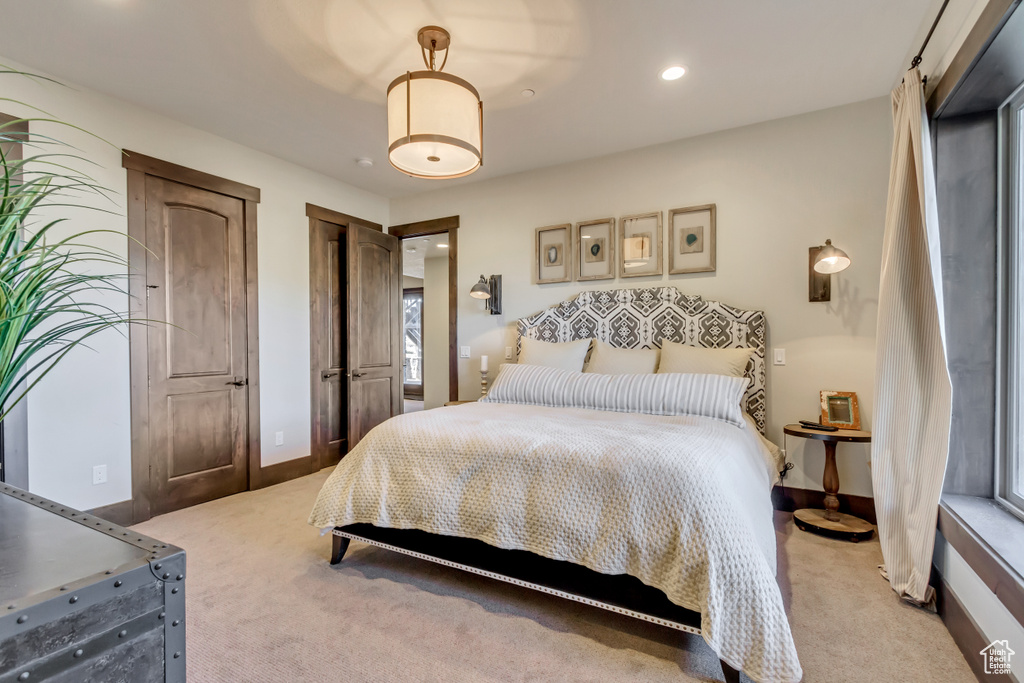 Bedroom with light carpet and recessed lighting