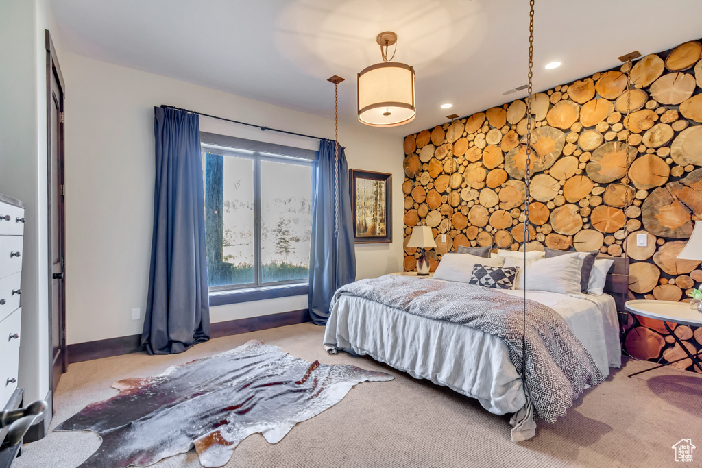 Bedroom featuring an accent wall, recessed lighting, and carpet