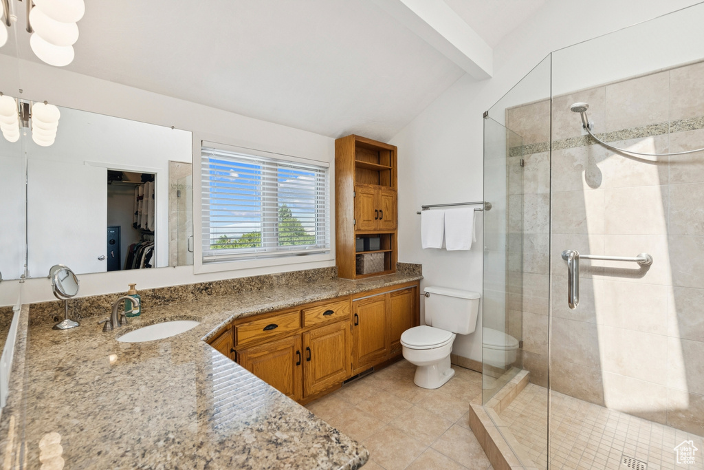 Full bath featuring a stall shower, vanity, and tile patterned flooring