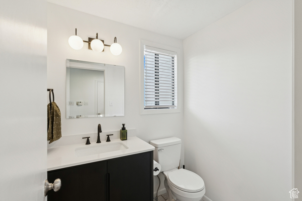 Half bath with vanity and toilet