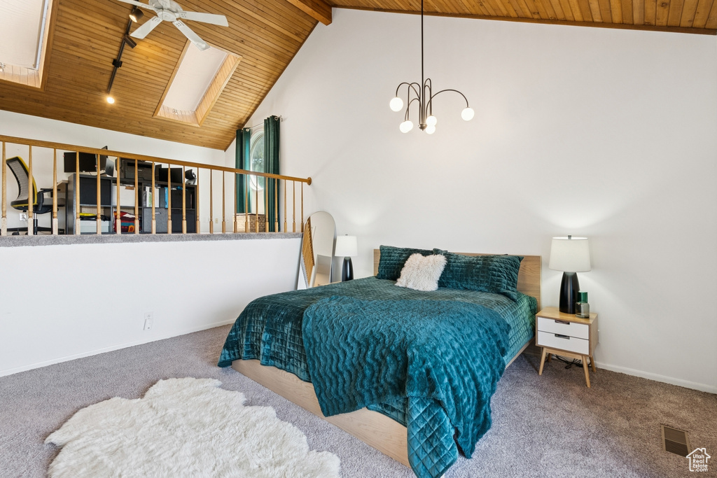 Bedroom with wooden ceiling, carpet flooring, a skylight, and a chandelier