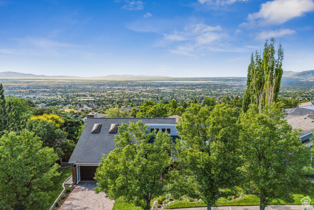 Aerial view of property and surrounding area featuring a mountain backdrop