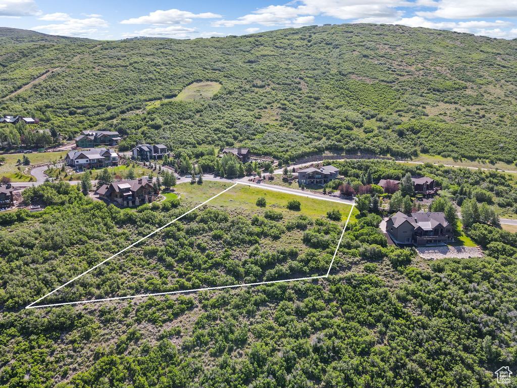 View of property location featuring property boundaries highlighted and a heavily wooded area