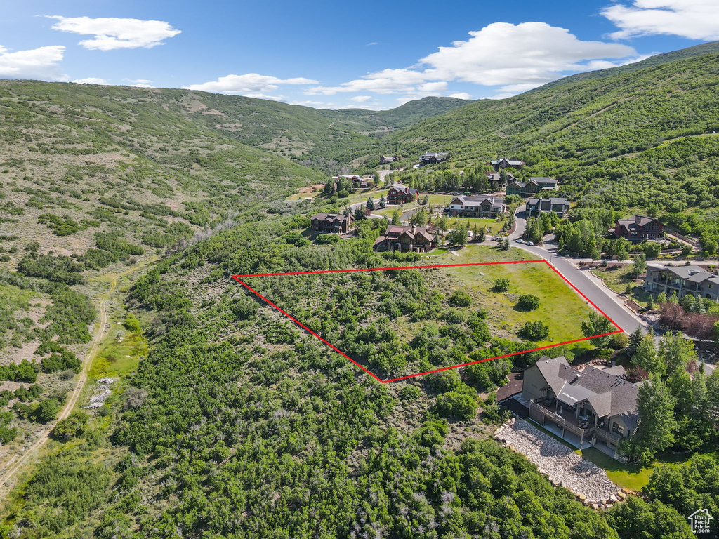 Aerial view of property\\\'s location with a mountainous background and property parcel outlined