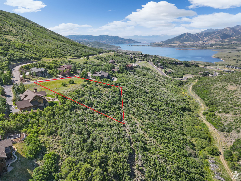 Aerial view of property and surrounding area featuring a water and mountain view and property boundaries highlighted