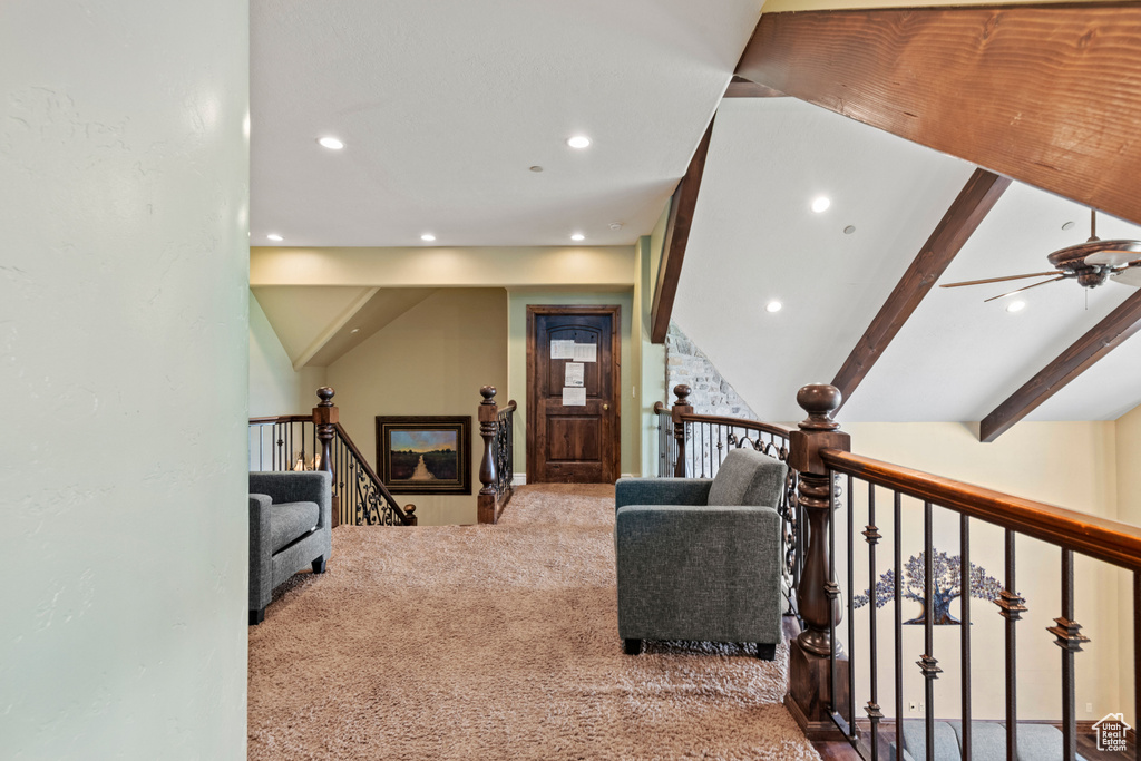 Carpeted living area with recessed lighting, ceiling fan, and beamed ceiling