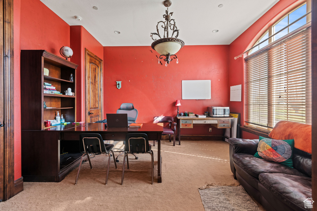 Carpeted home office with plenty of natural light