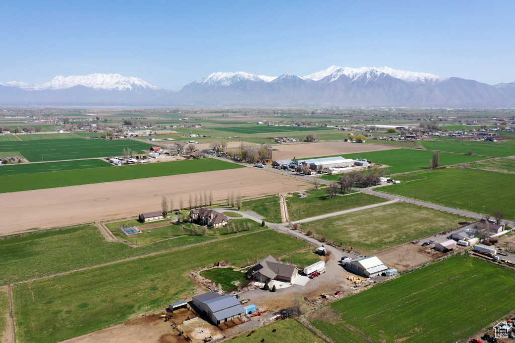 Aerial view of property's location with rural landscape and a mountainous background