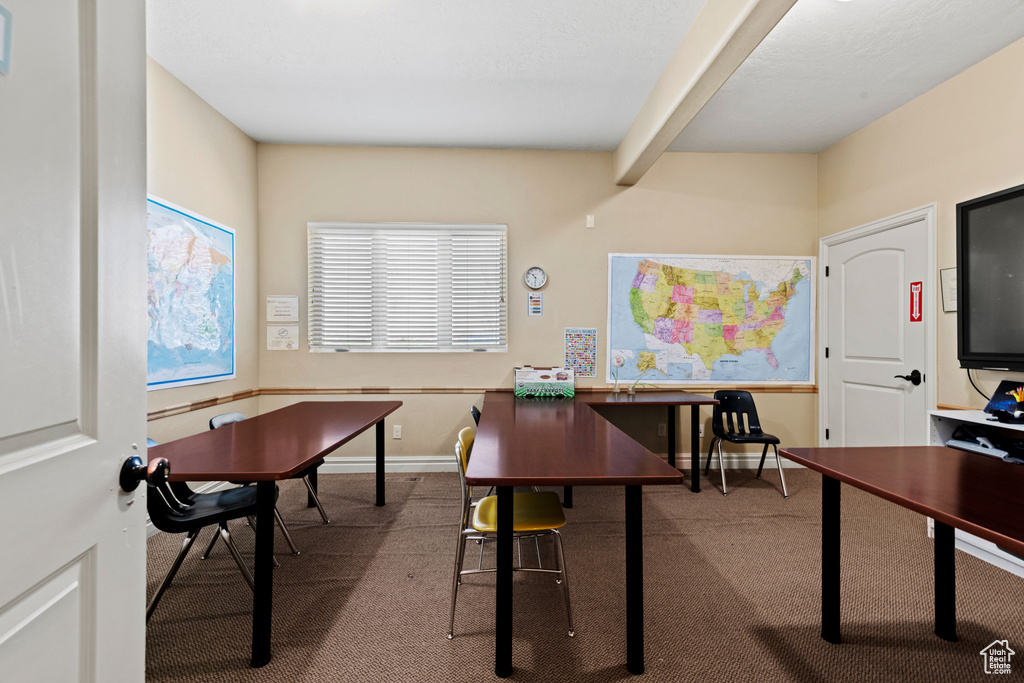 Office featuring carpet flooring and beam ceiling